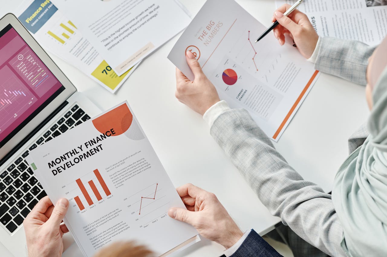 about-img Top view of business colleagues analyzing financial reports during a meeting at the office.